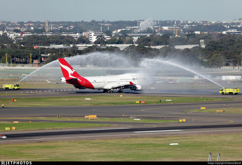 a jet plane spraying water on runway