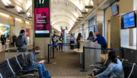 people sitting in chairs in a terminal