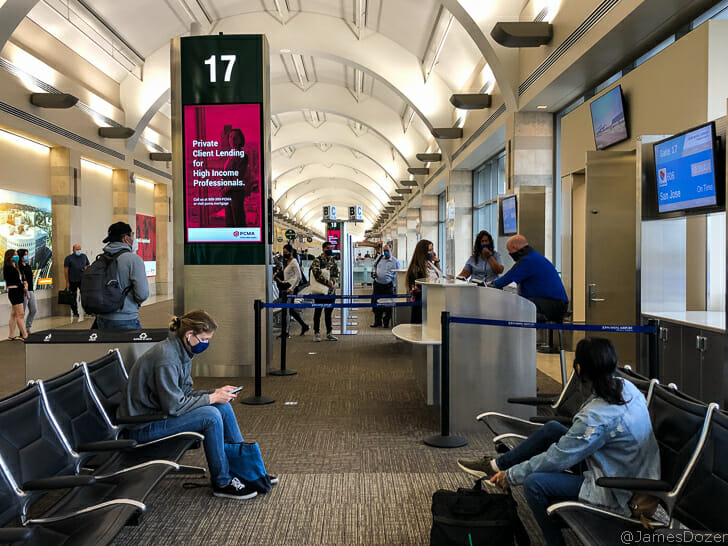 people sitting in chairs in a terminal