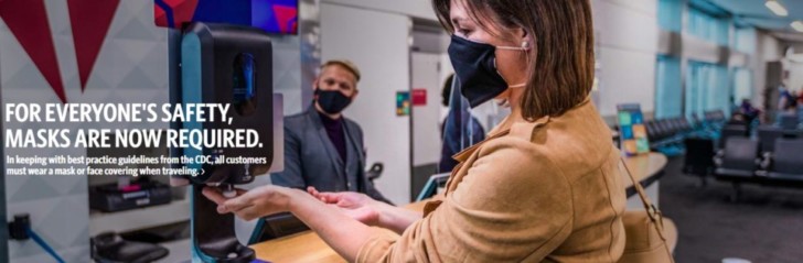 a woman wearing a face mask and using a hand sanitizer