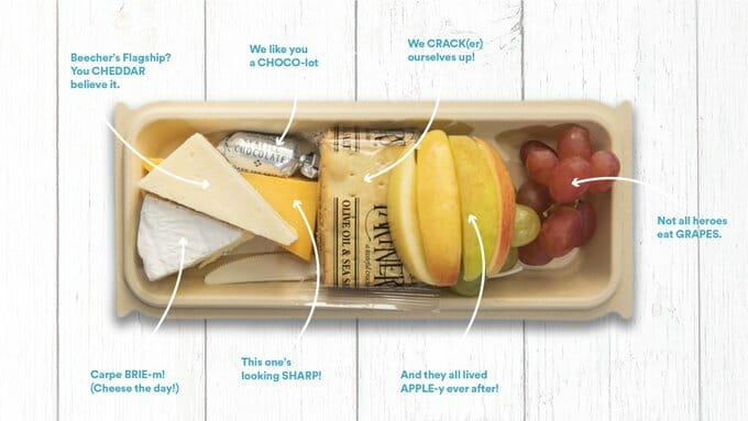 a tray of food with fruits and cheese