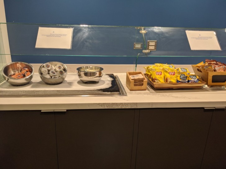 a counter with bowls and bowls of food