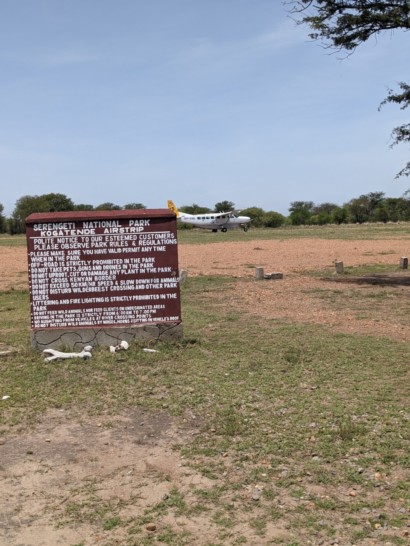 a sign with a plane in the background