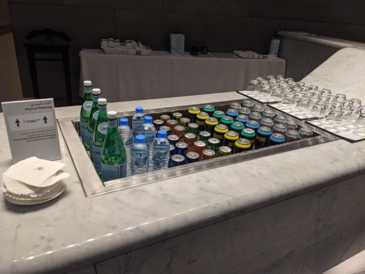 a row of bottles and water bottles in a sink