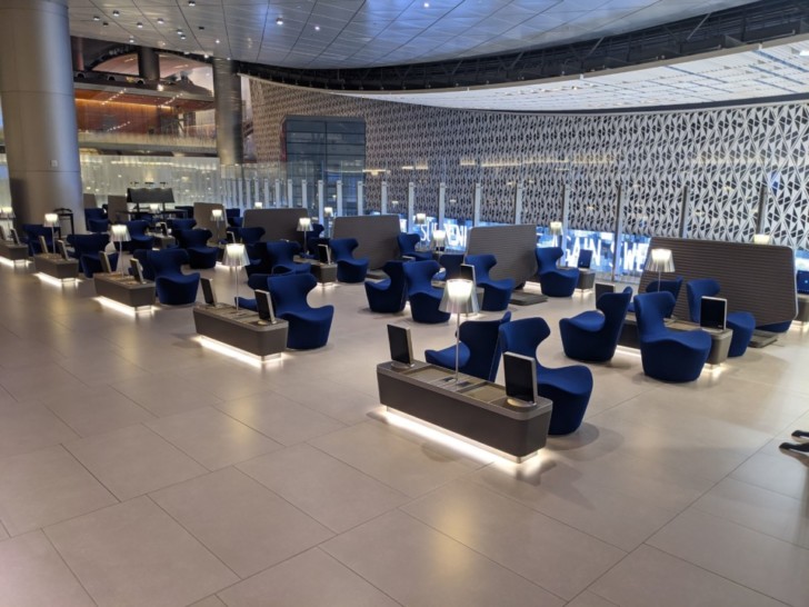 a room with blue chairs and a laptop