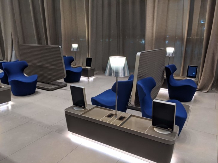 a room with blue chairs and a table