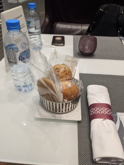 a plate with food in it and water bottles on a table