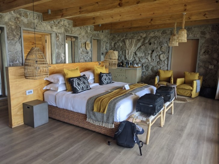a room with a bed and luggage