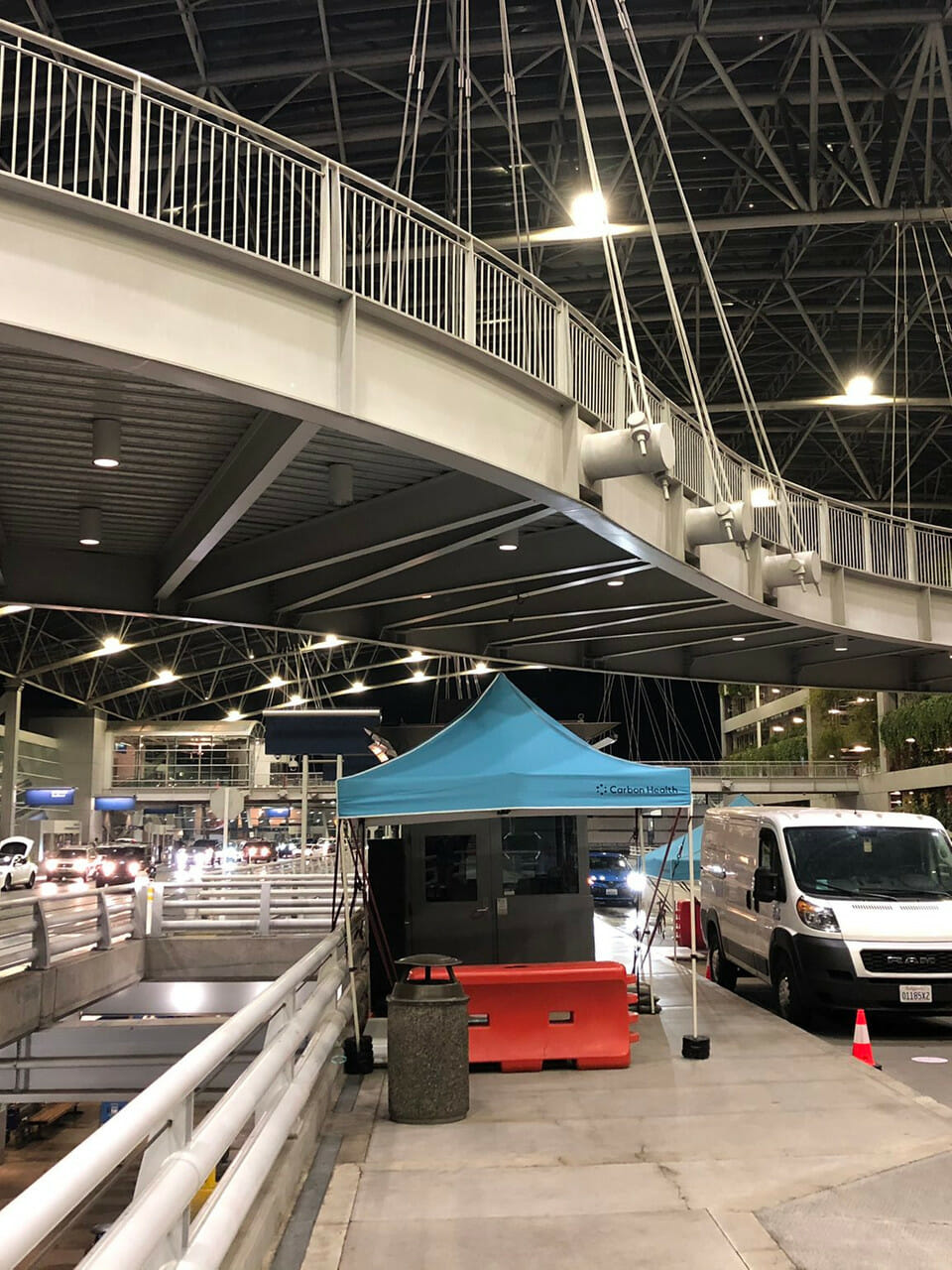 a building with a tent and cars