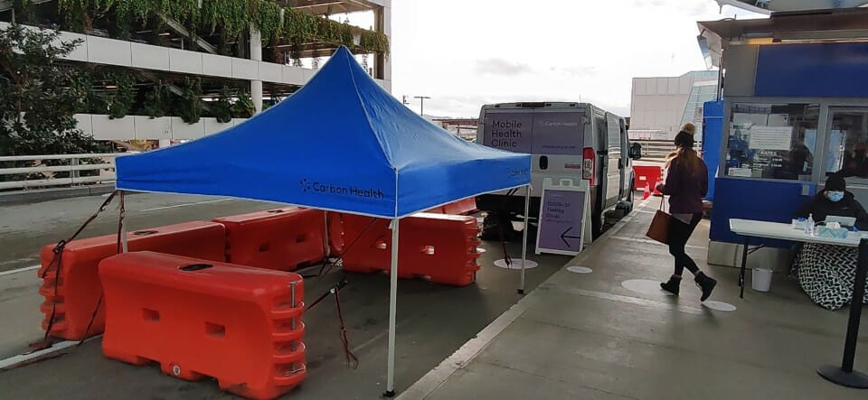 a blue tent next to a van