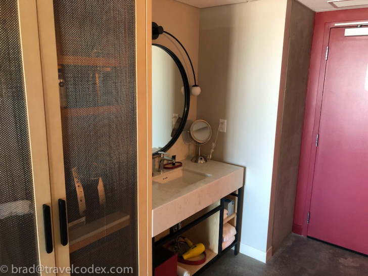 a bathroom with a mirror and a shelf