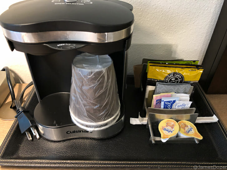a coffee maker with a plastic bag on a table