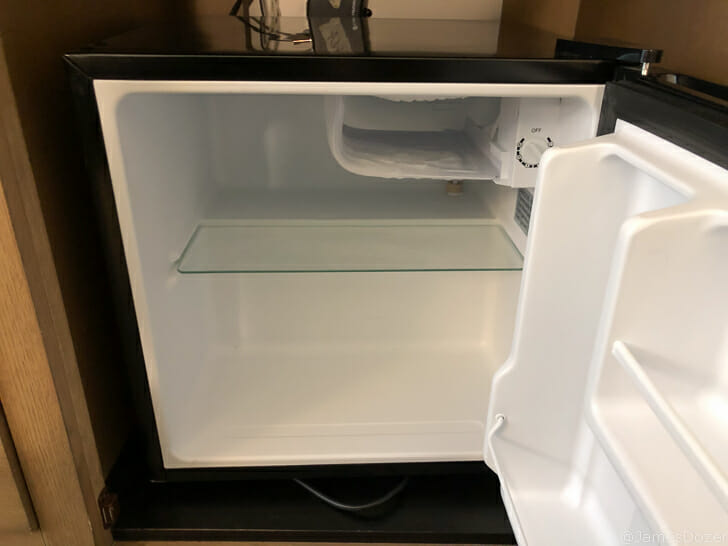 a small refrigerator with a door open