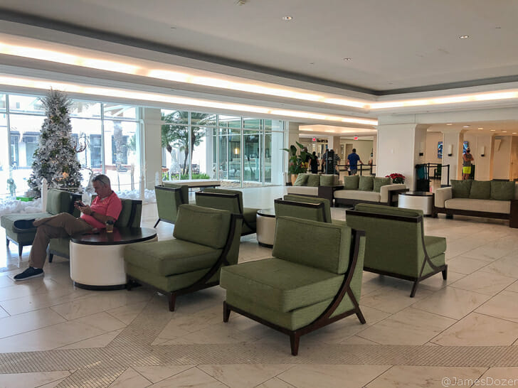 a man sitting at a table in a lobby