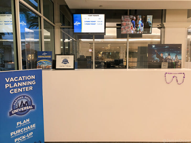 a reception desk with a sign and a poster