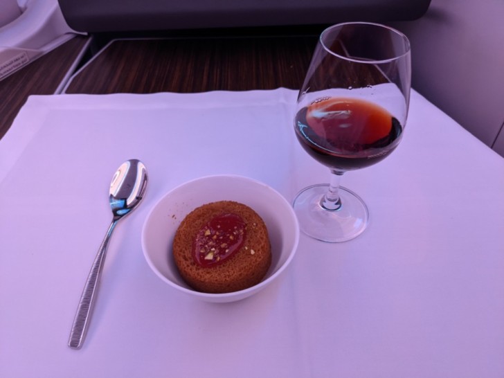 a cup of wine and a dessert in a bowl