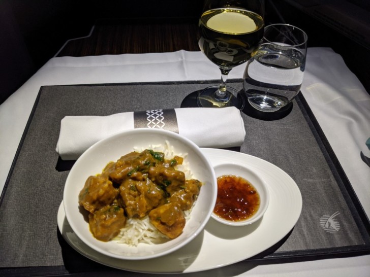 a plate of food and a glass of wine