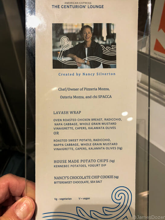 a hand holding a menu