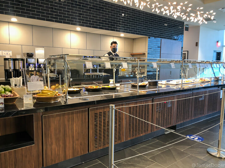 a person behind a counter with food in it