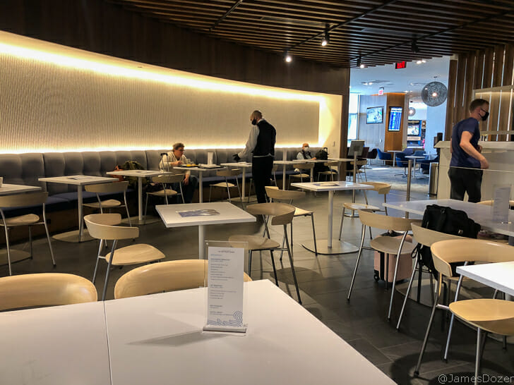 a group of people sitting at tables in a restaurant