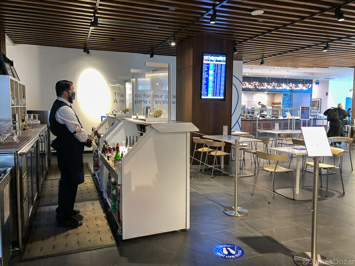 a man standing at a counter in a restaurant