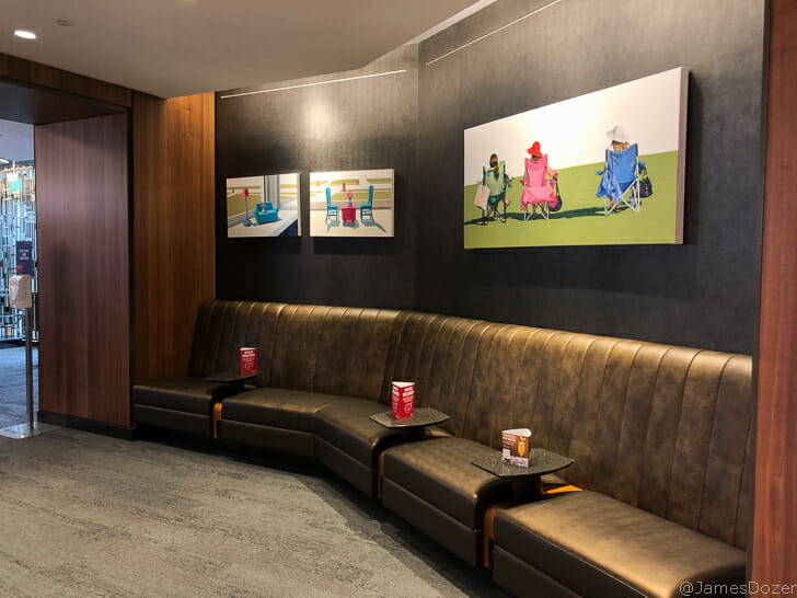 a long couch with a group of pictures on the wall