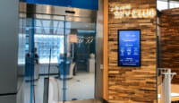 a glass door with a sign on the wall