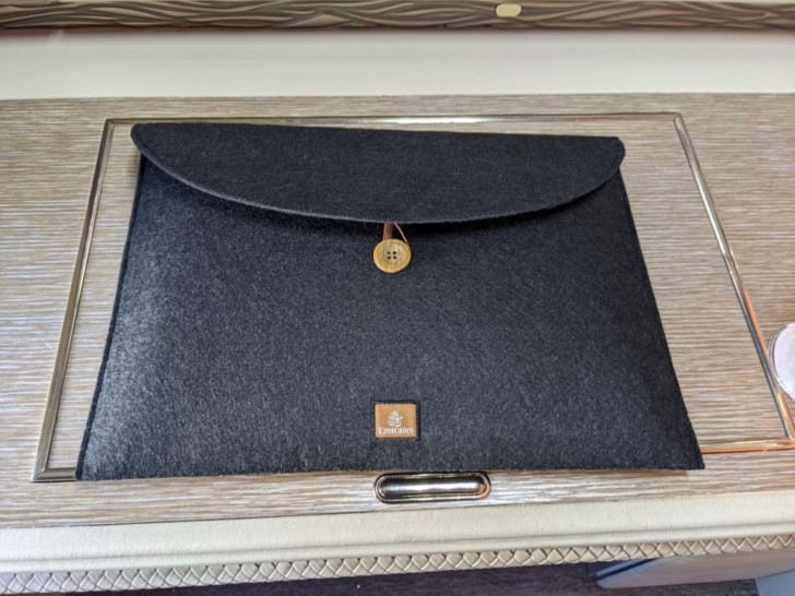 a black felt envelope on a wood surface