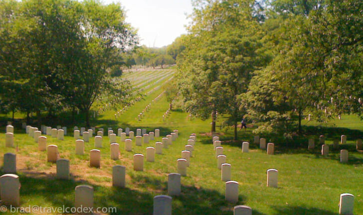 a cemetery with many white headstones