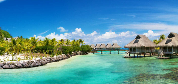 a body of water with a hut and a bridge