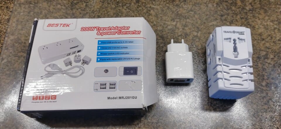 a white box with a white adapter and a white box with black buttons