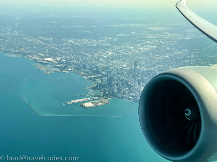 an airplane wing and water and city