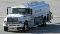 a white truck with a tank on the side