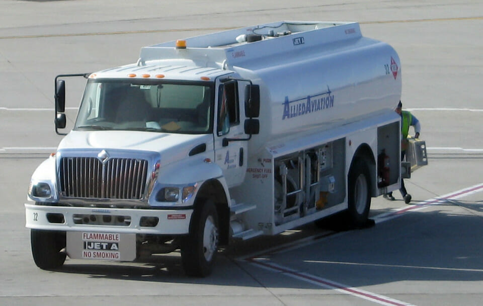 a white truck with a tank on the side