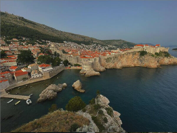 a city on a cliff by water