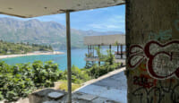 a building with a view of the water and mountains