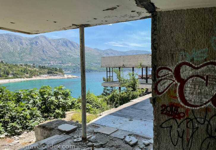 a building with a view of the water and mountains