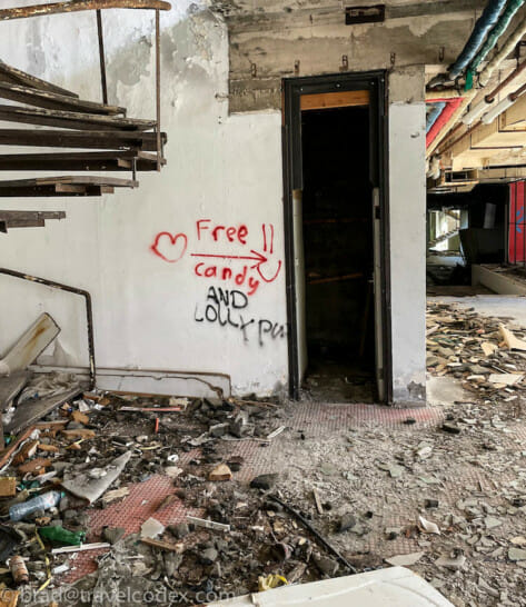 a door in a building with graffiti on the wall