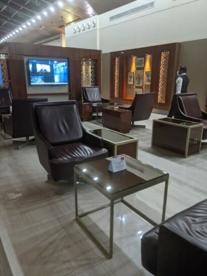a room with leather chairs and a glass table