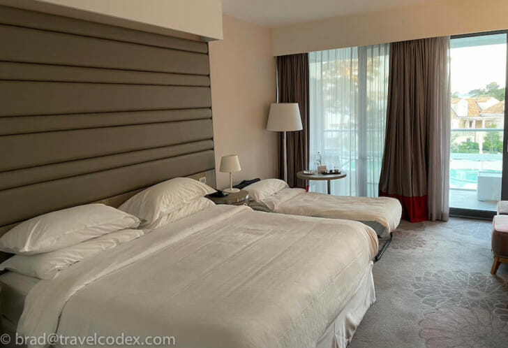 a room with two beds and a window