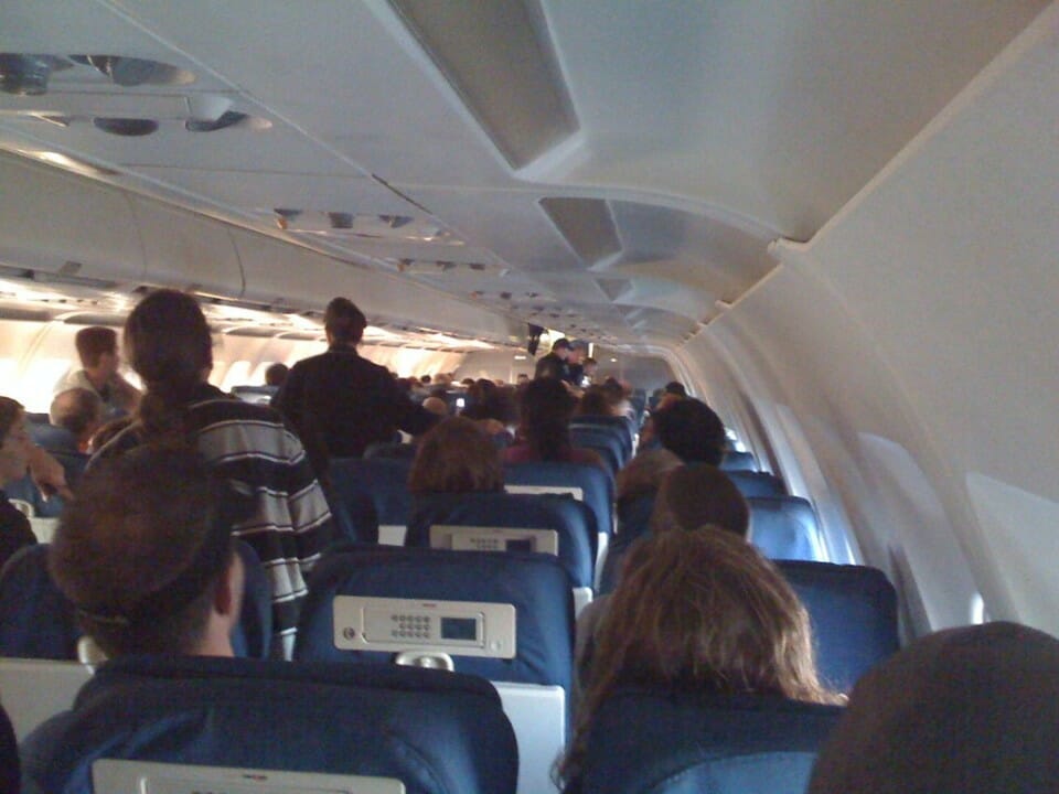 a group of people sitting in an airplane