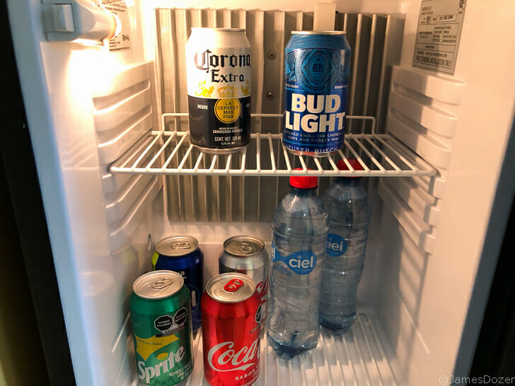 a refrigerator with cans and cans of beer