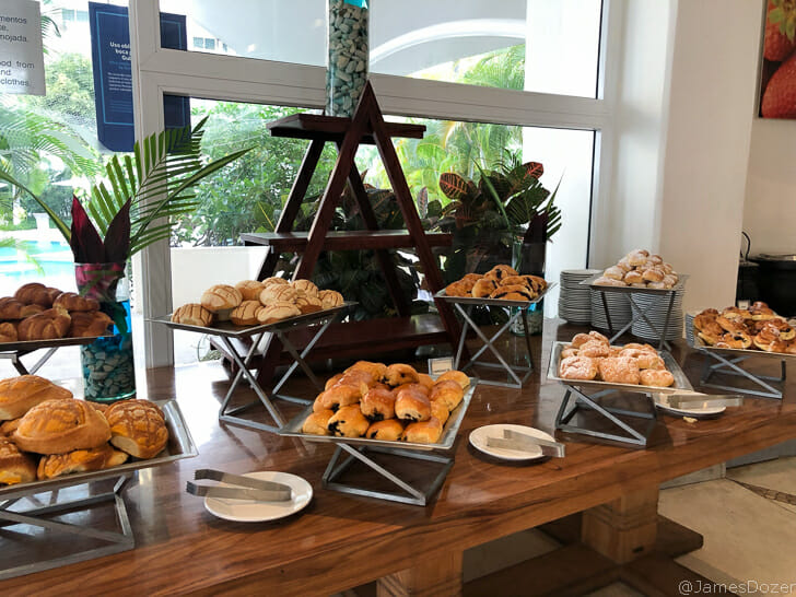 a table with trays of pastries