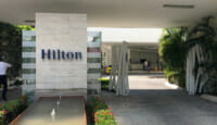 a building with a fountain and a sign