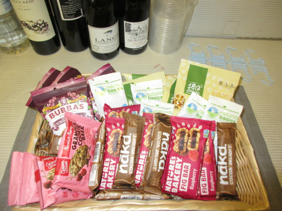 a basket of food and wine bottles