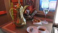 a coffee pot and two cups of tea