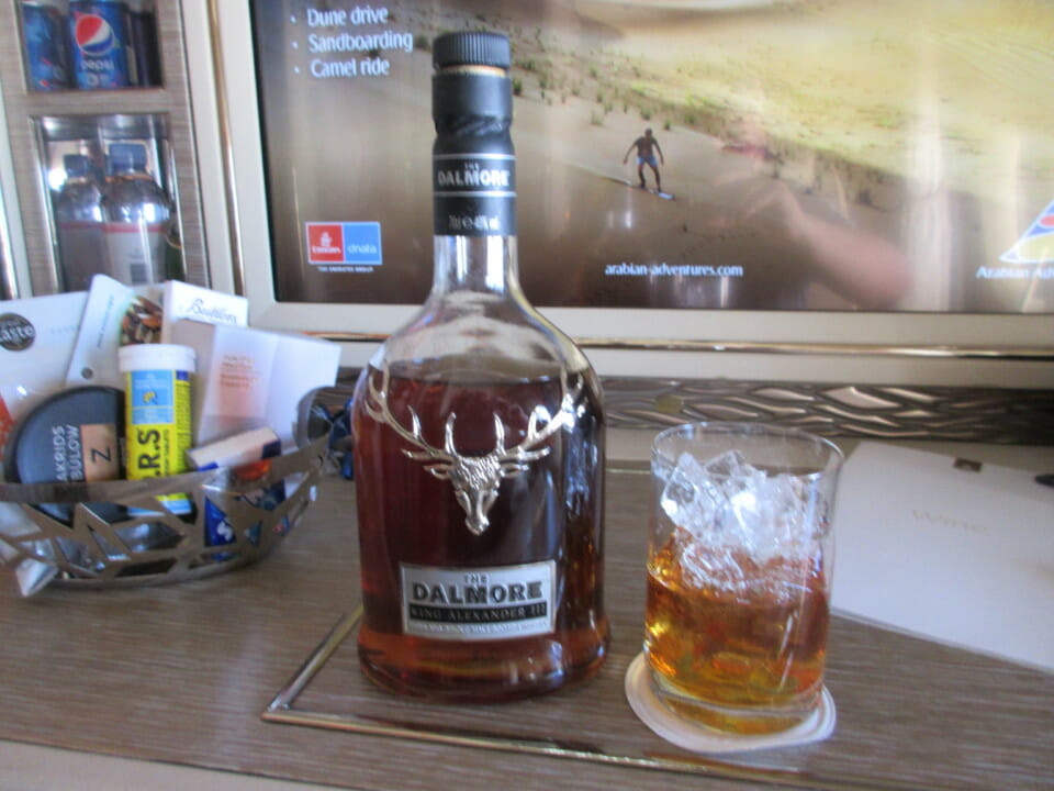 a bottle of alcohol and a glass of ice