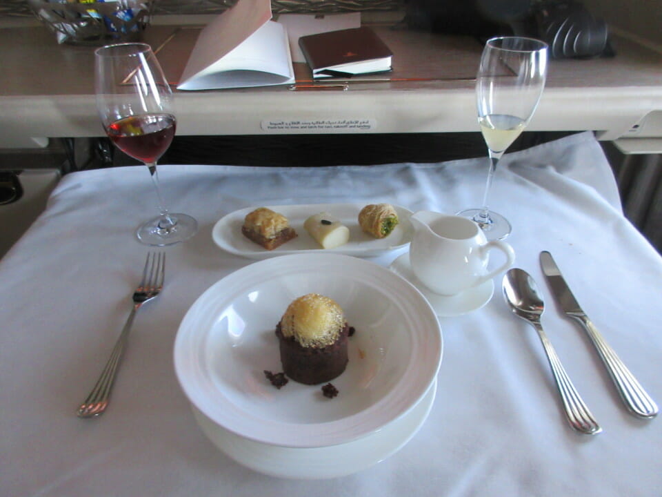 a plate of desserts and wine on a table