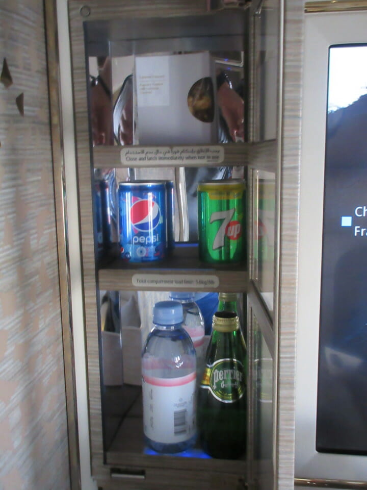 a shelf with soda and water bottles