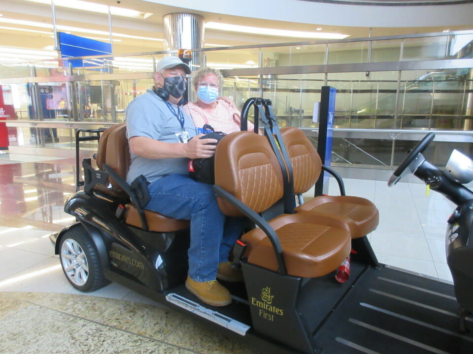 a man and woman in a golf cart